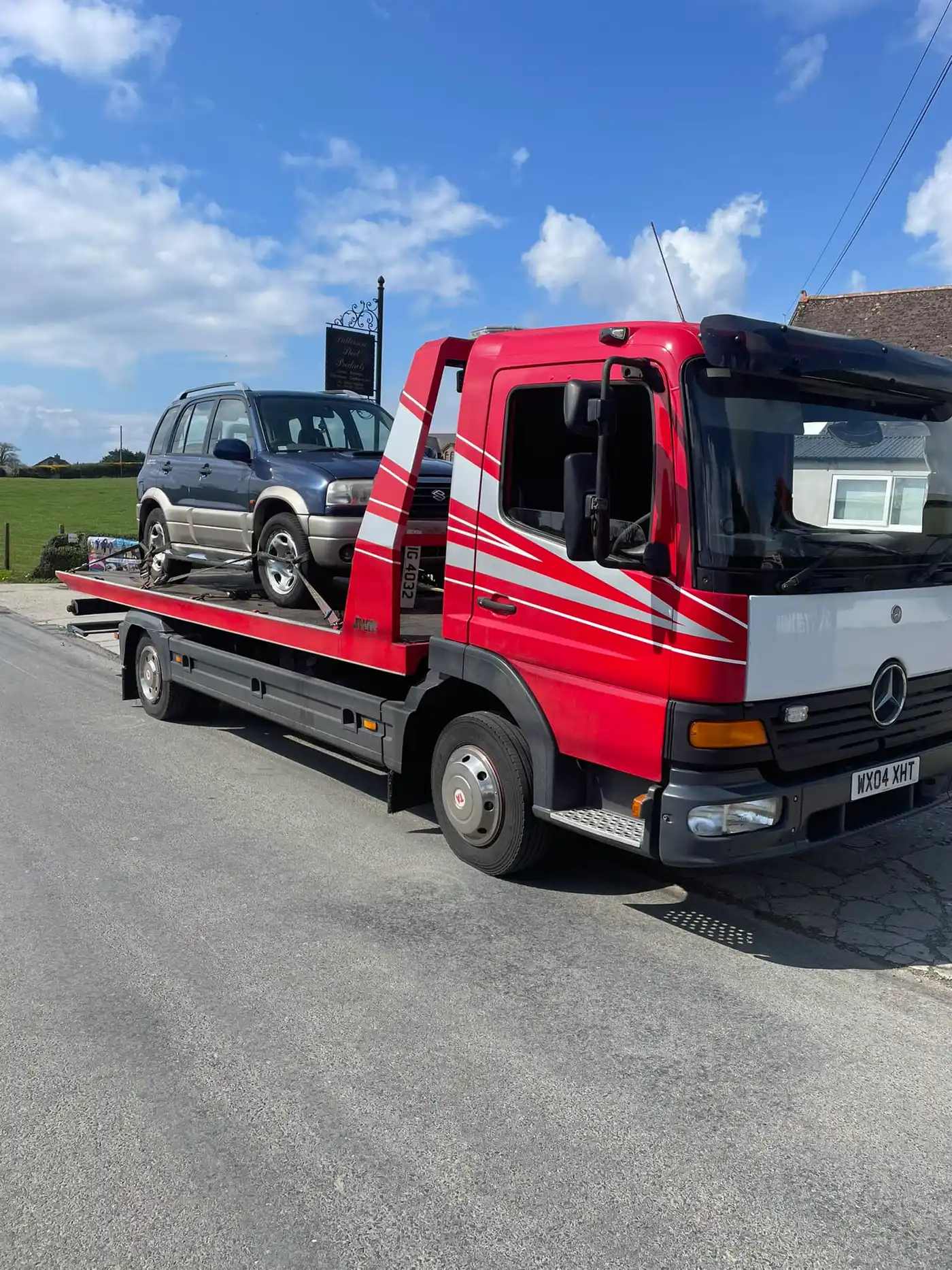 Suzuki jeep on recovery truck